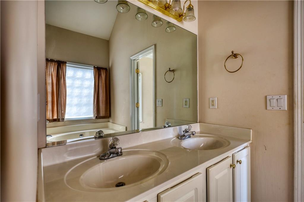 2648 Neighborhood Walk Villa Rica, GA 30180 - Photo 27 of 40 a bathroom with a sink and a mirror