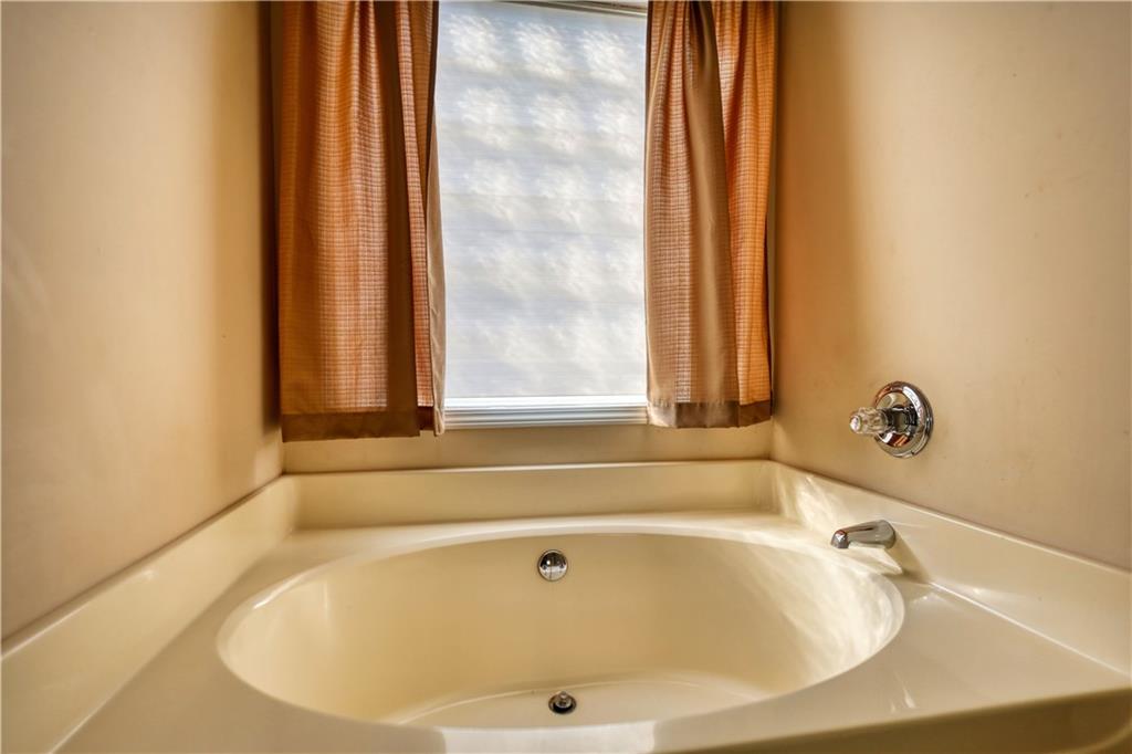 2648 Neighborhood Walk Villa Rica, GA 30180 - Photo 28 of 40 a bathroom with bathtub and window