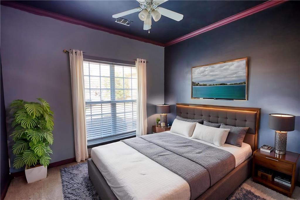 2648 Neighborhood Walk Villa Rica, GA 30180 - Photo 31 of 40 a bedroom with a large bed and a chandelier