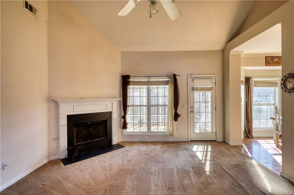 2648 Neighborhood Walk Villa Rica, GA 30180 - Photo 7 of 40 a view of an empty room with exposed radiator and fireplace