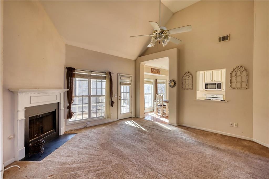 2648 Neighborhood Walk Villa Rica, GA 30180 - Photo 9 of 40 a view of an empty room with a fireplace and a window