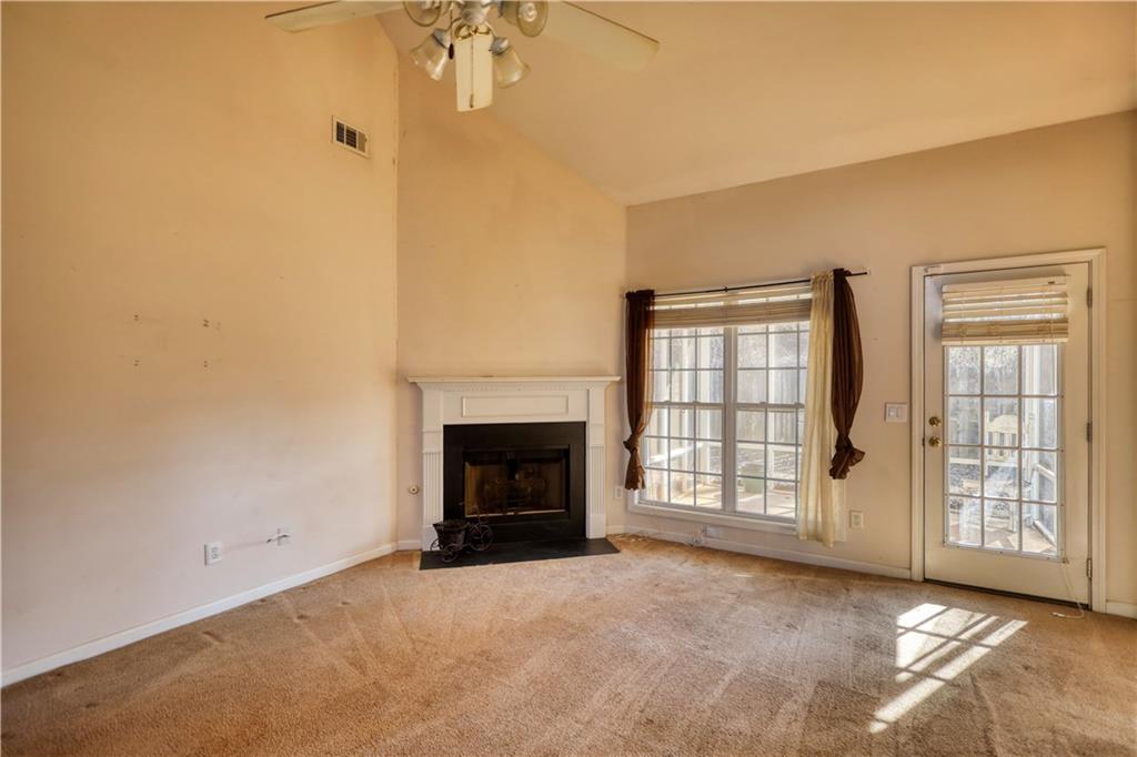 2648 Neighborhood Walk Villa Rica, GA 30180 - Photo 10 of 40 a view of an empty room with a fireplace and a window