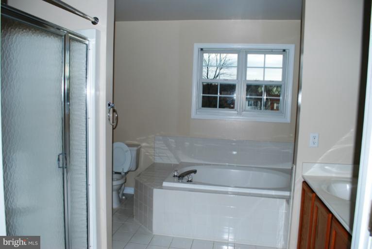 9303 Sandra Park Road Perry Hall, MD 21128 - Photo 17 of 25 a bathroom with a tub and a window