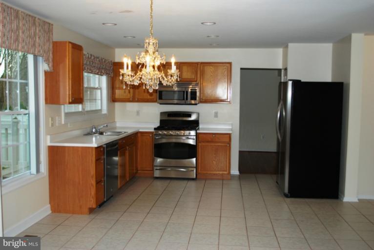 9303 Sandra Park Road Perry Hall, MD 21128 - Photo 4 of 25 a kitchen with stainless steel appliances granite countertop a refrigerator and a stove