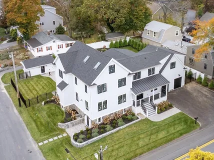 a view of a house with a big yard and large trees