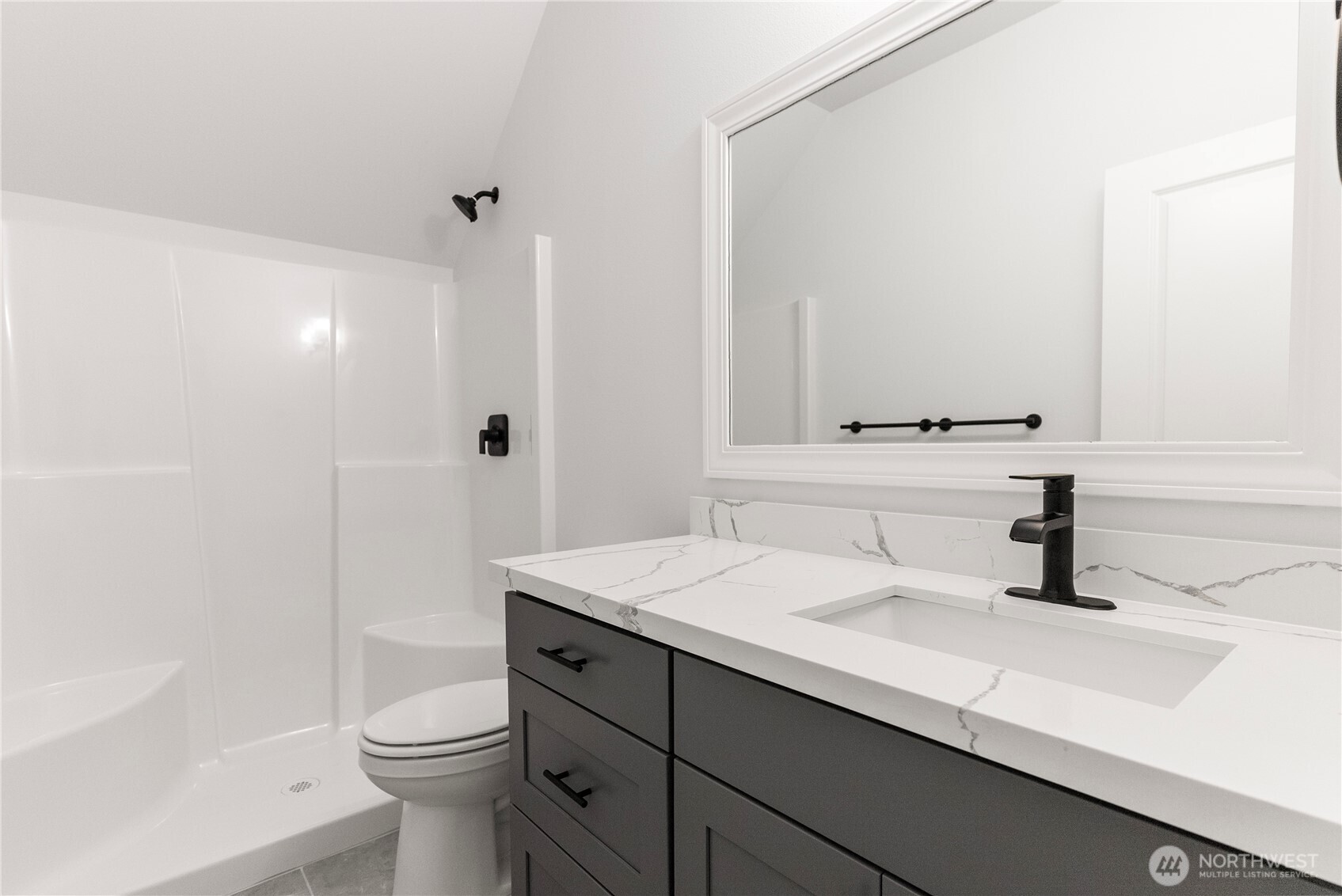 14317 Mima Road Southwest Olympia, WA 98512 - Photo 16 of 39 a bathroom with a sink a toilet a mirror and shower