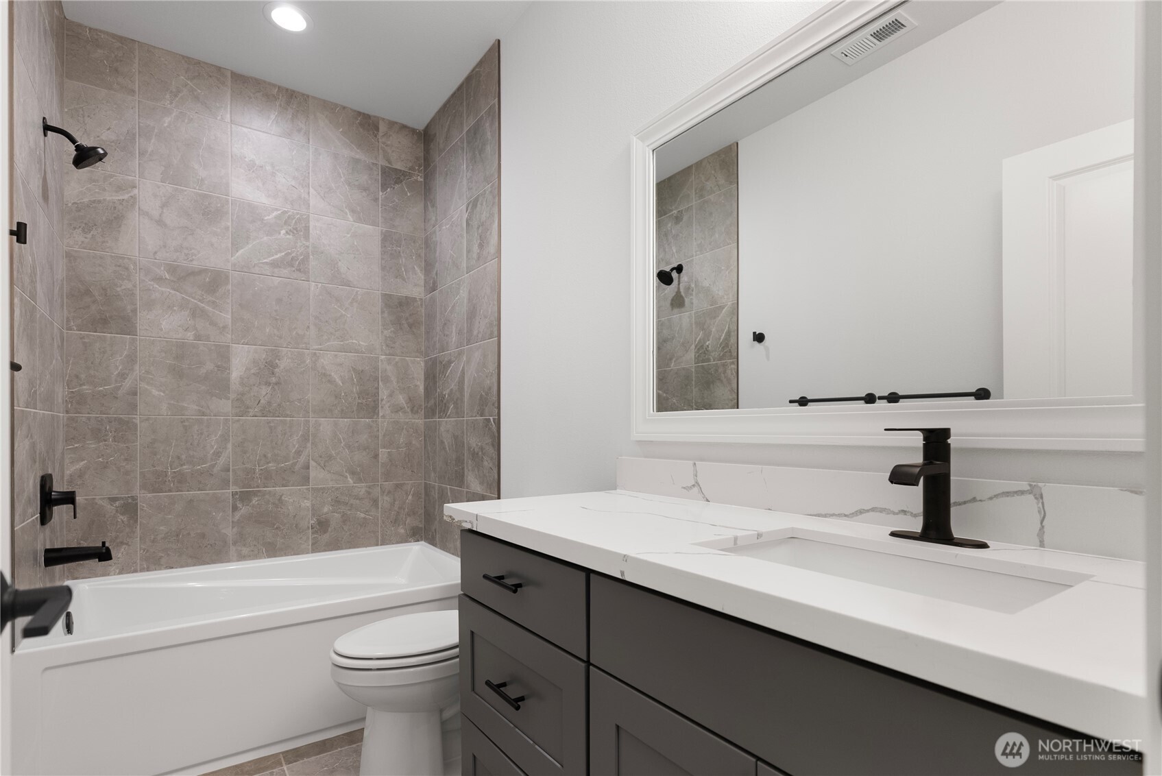14317 Mima Road Southwest Olympia, WA 98512 - Photo 27 of 39 a bathroom with a bathtub shower sink vanity mirror and toilet