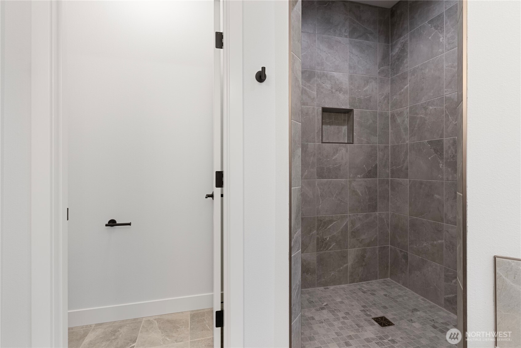 14317 Mima Road Southwest Olympia, WA 98512 - Photo 31 of 39 a bathroom with a glass shower door
