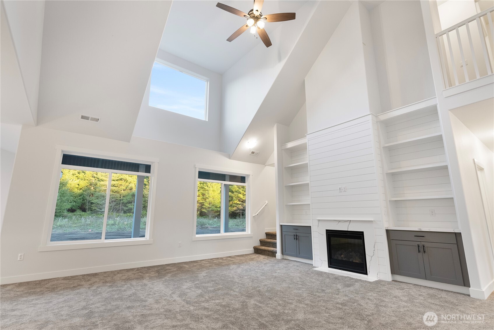 14317 Mima Road Southwest Olympia, WA 98512 - Photo 6 of 39 an empty room with windows and fireplace