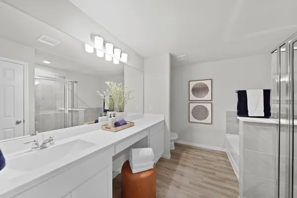 a bathroom with a sink double vanity granite and a mirror