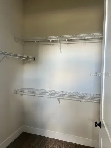 wooden floor in an empty room with a mirror