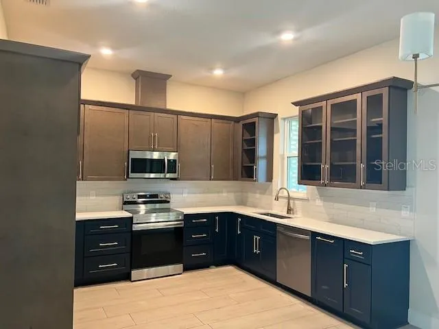 a kitchen with a sink and a stove