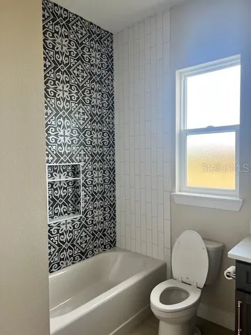 a bathroom with a toilet and a bathtub