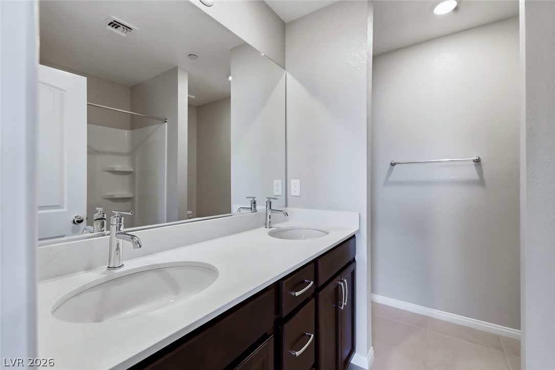 3564 Credere Lane Henderson, NV 89074 - Photo 31 of 40 Full bath with double vanity, a shower, and light tile patterned floors