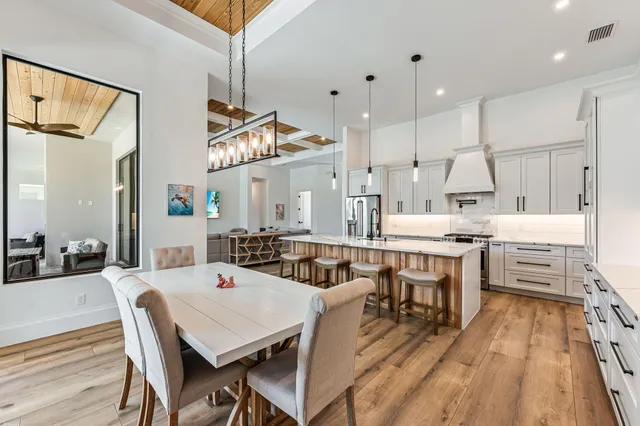 a large kitchen with a table and chairs