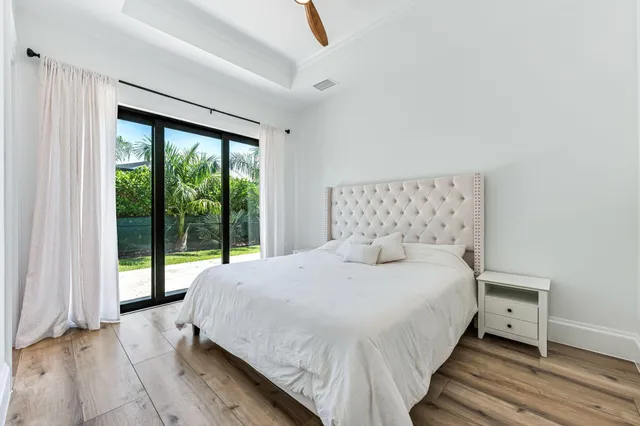 a bedroom with a bed and a large window