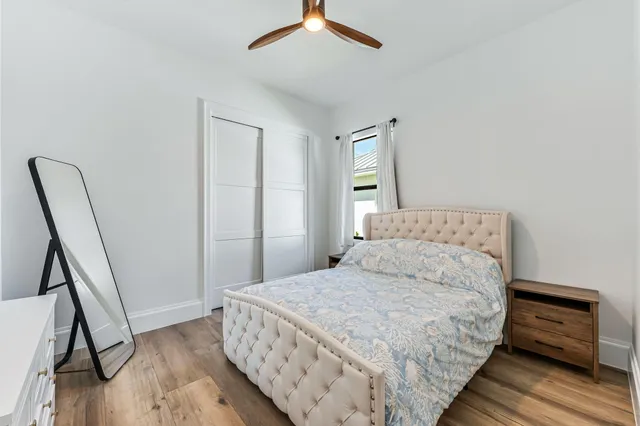 a bedroom with a bed and a flat tv screen on the dresser
