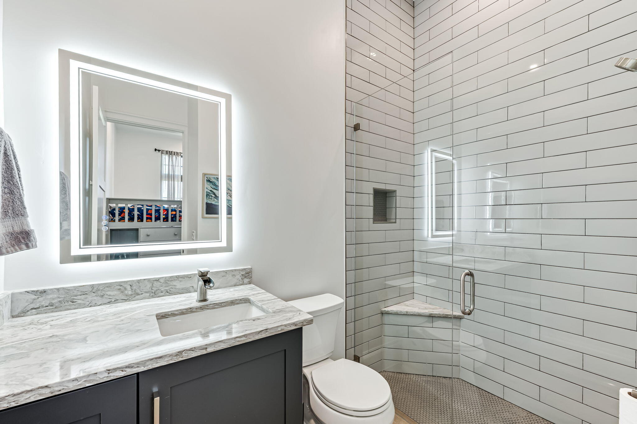 1362 San Marco Road Marco Island, FL 34145 - Photo 29 of 45 a bathroom with a granite countertop toilet a sink a mirror and a shower