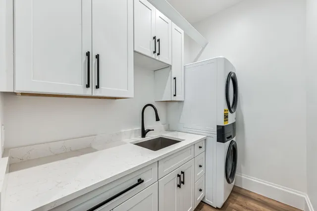 a kitchen with stainless steel appliances a sink a stove and cabinets