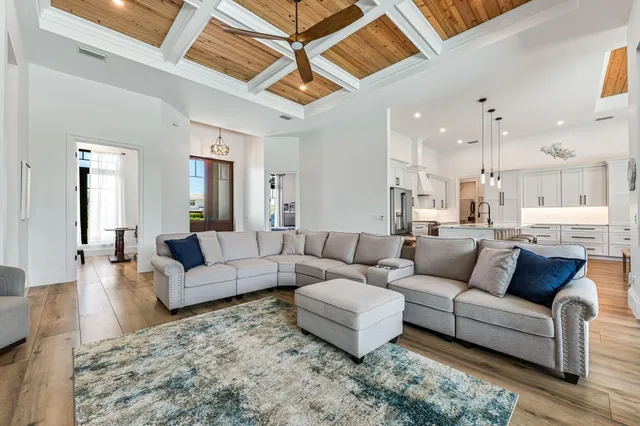 a living room with furniture and view of kitchen