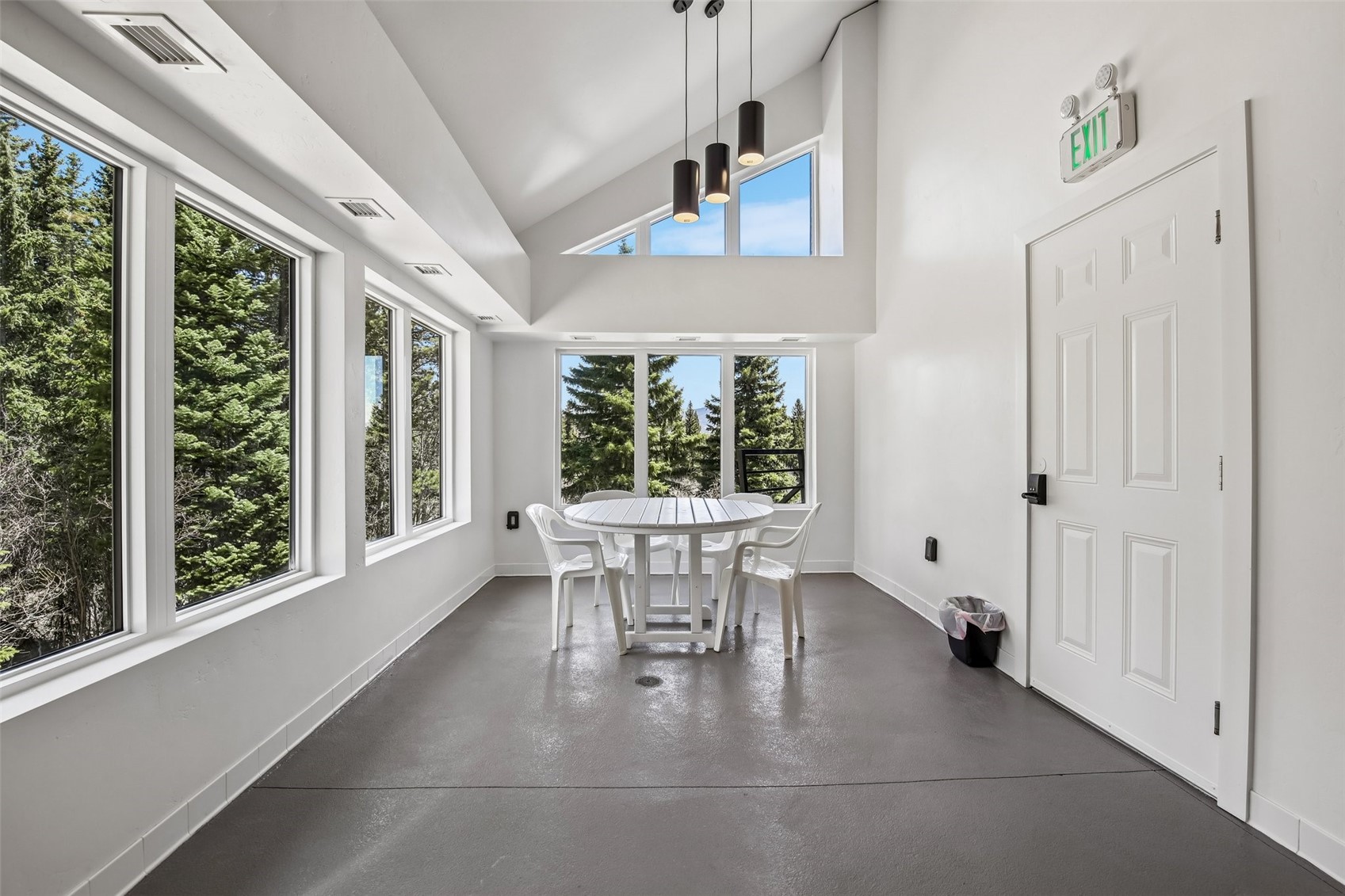 89310 Ryan Gulch Road, Unit 103 Silverthorne, CO 80498 - Photo 36 of 48 a dining room with furniture and large windows