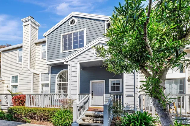 a front view of a house with plants