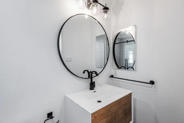 a bathroom with a sink and mirror