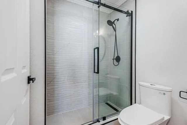 a bathroom with a toilet and a shower