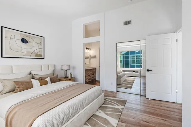 a bedroom with a bed and glass door