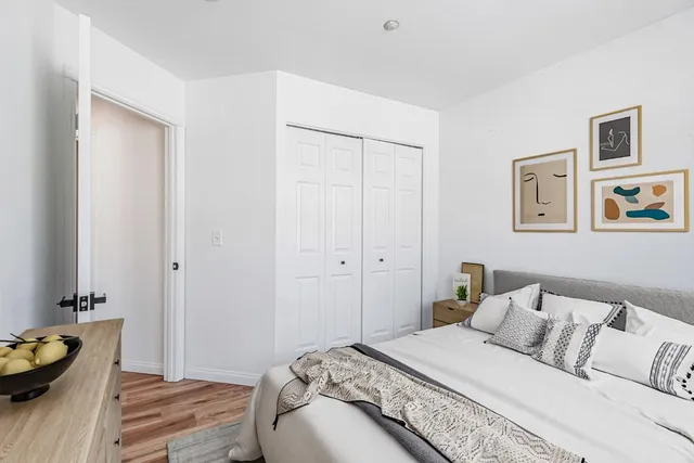 a bedroom with a bed and a window