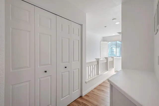a view of a hallway with wooden floor and entryway