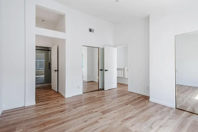 a view of empty room with wooden floor