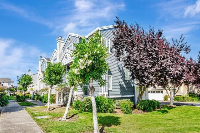 a front view of a house with a yard and a garden