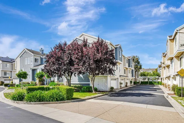 a view of street along with house and trees