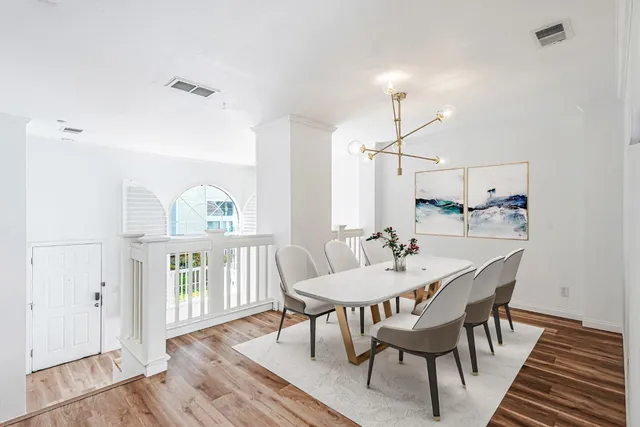 a dining room with furniture a rug and wooden floor