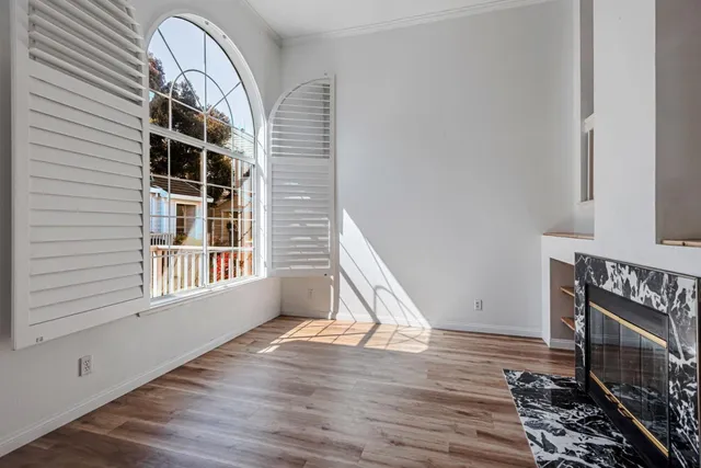 a view of a livingroom with wooden floor and a window