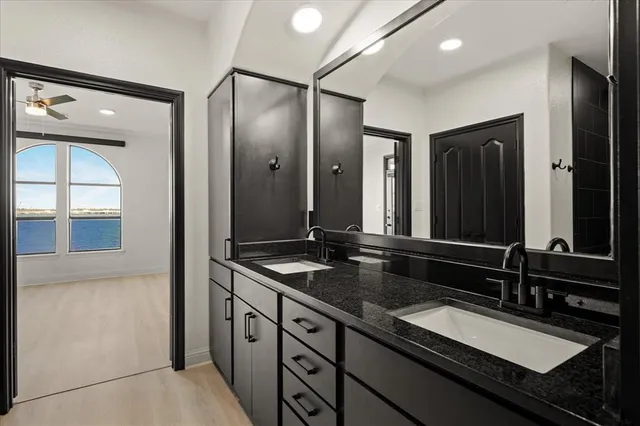 a bathroom with a granite countertop sink and a mirror