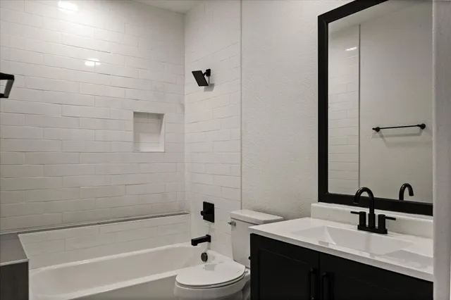 an empty room with a window and a ceiling fan