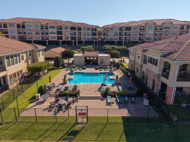 an aerial view of a house with swimming pool and outdoor seating
