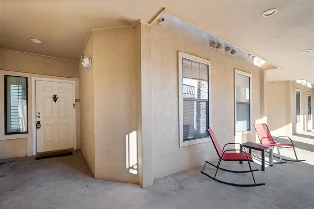 a living room with furniture and floor to ceiling window