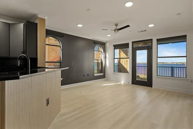 a view of an empty room with glass door and a window