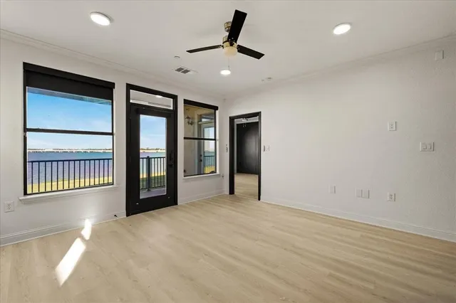 a view of a livingroom with a ceiling fan and window