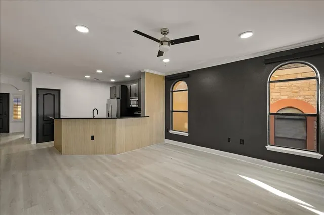 a kitchen with stainless steel appliances granite countertop a refrigerator and a sink