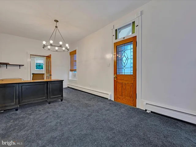 a view of a livingroom with furniture and chandelier