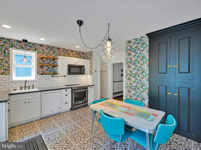 a large kitchen with a table and chairs
