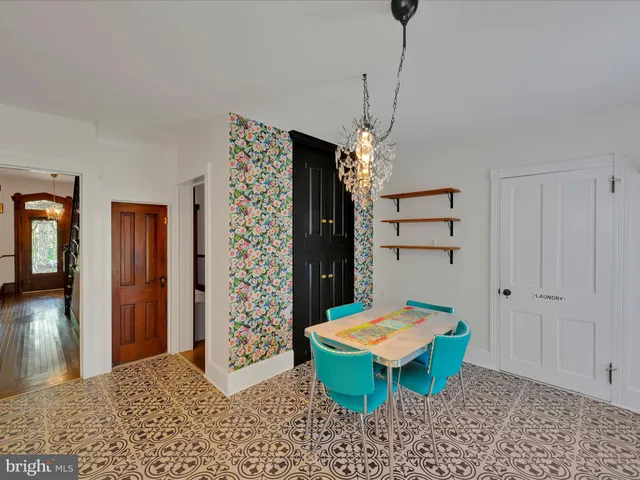 a living room with a table chairs and a table