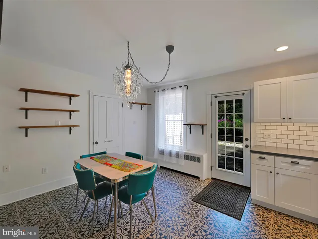 a room with furniture pool table and window