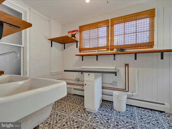 a bathroom with a sink a toilet and bathtub