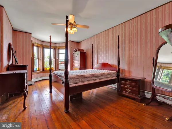 a bedroom with furniture and wooden floor