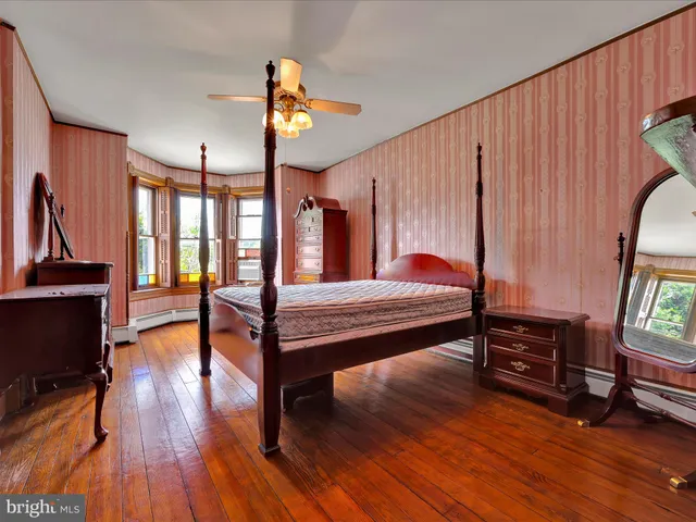 a bedroom with furniture and wooden floor